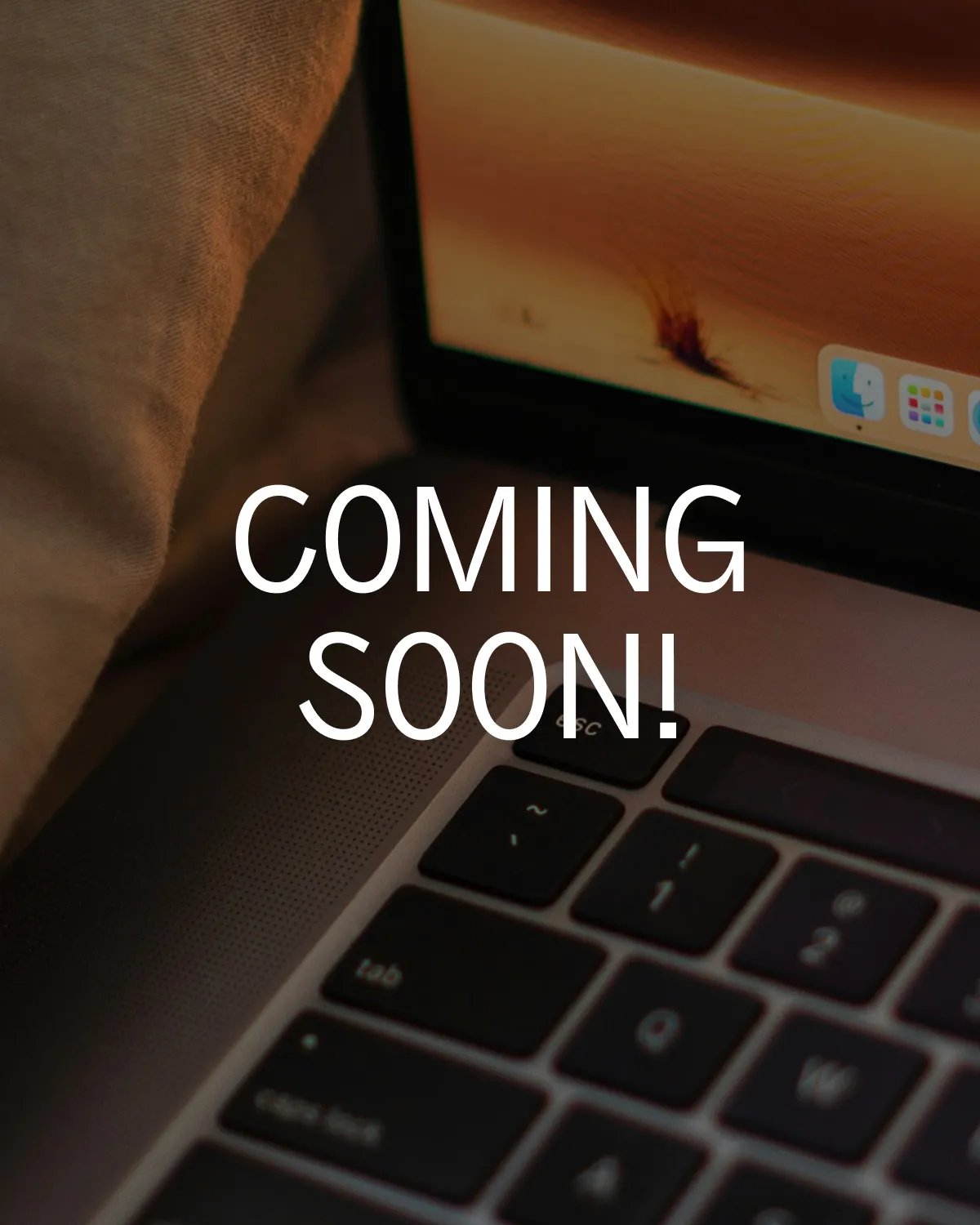 Close-up of a laptop keyboard and screen with the text „COMING SOON!“ overlaid in bold white letters. Close-up of a laptop keyboard and screen with the text