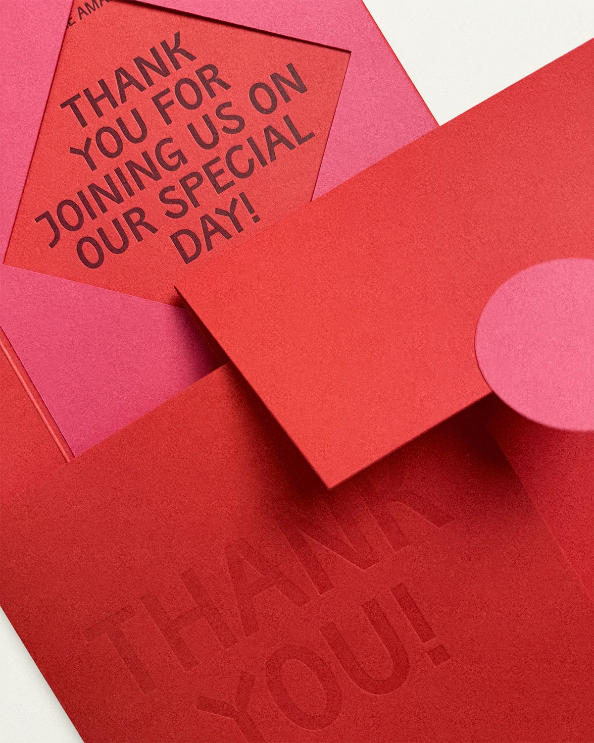 Close-up of the vibrant Kir Royale Suite including Thank You card, belly band, and envelope.