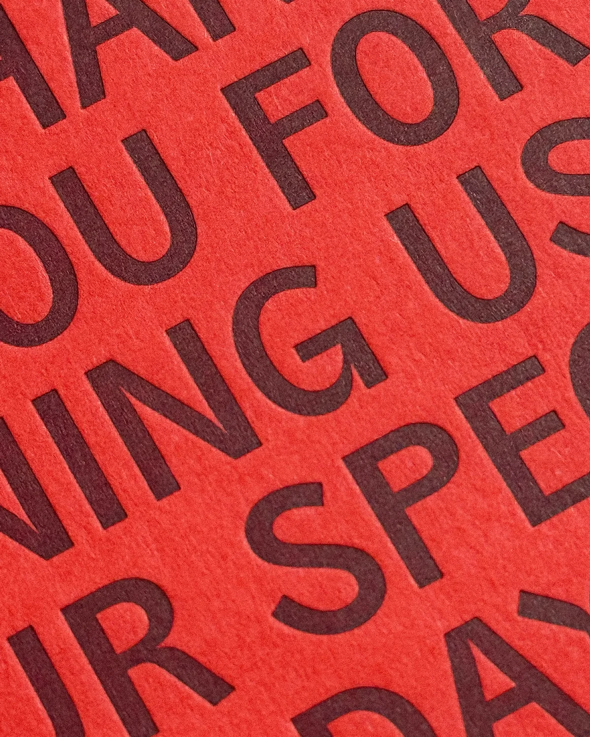 Close-up of letterpress Kir Royal Suite thank-you card in vibrant red.