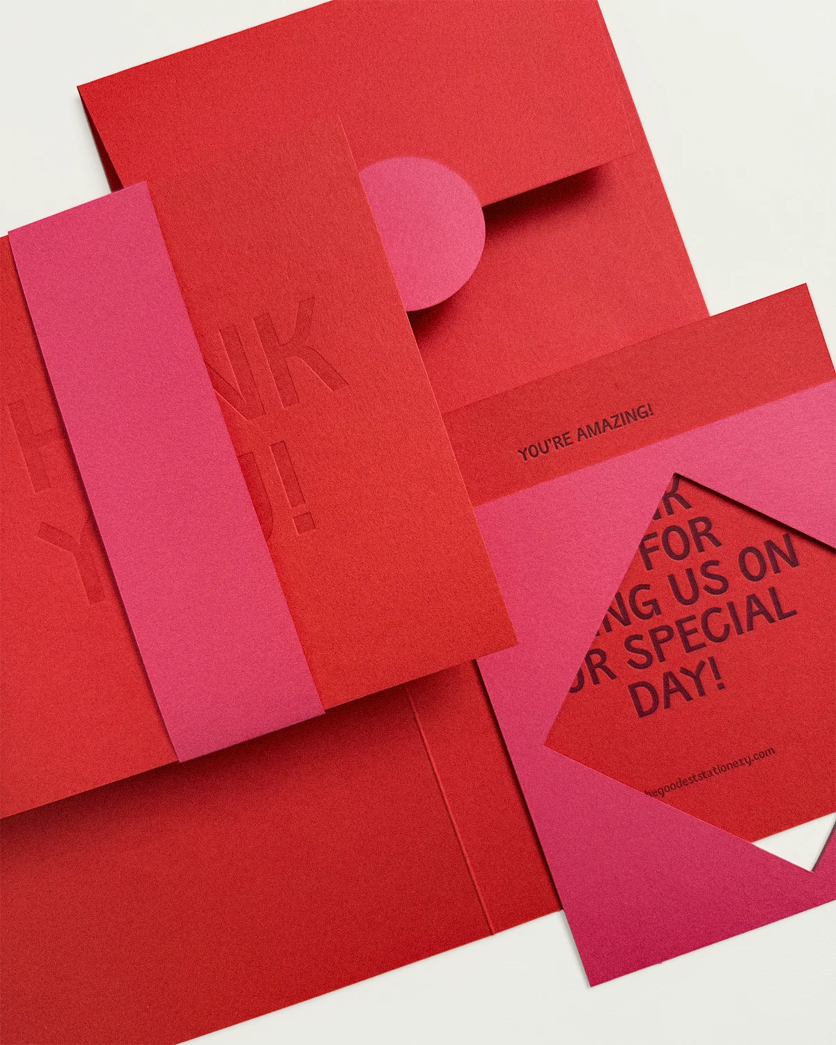 Pile of the vibrant Kir Royale Suite including Thank You card, belly band, and envelope.