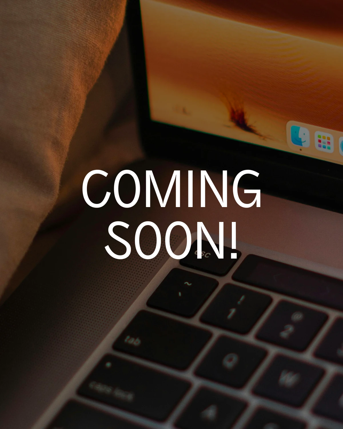 Close-up of a laptop keyboard and screen with the text „COMING SOON!“ overlaid in bold white letters. Close-up of a laptop keyboard and screen with the text